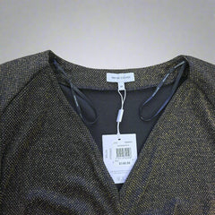 Black and gold dress with tags on a light background