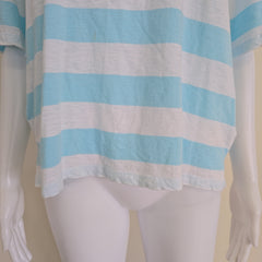 Mannequin wearing a blue and white striped top on a plain background