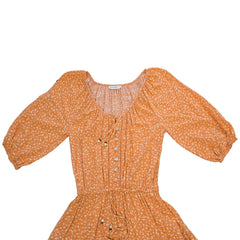 Orange floral dress on a light background