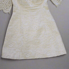 White textured dress on a tiled floor