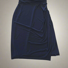 Folded navy blue fabric on a tiled floor