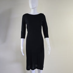 Black dress on a mannequin with a plain background