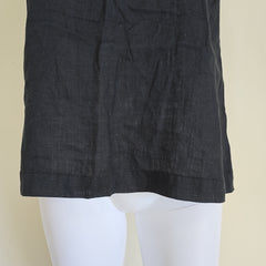 Black fabric draped over a white mannequin on a beige background