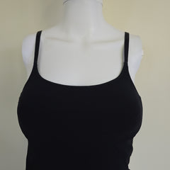 Black tank top on a mannequin against a beige background
