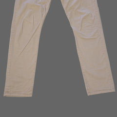 Beige pants laid flat on a tiled floor