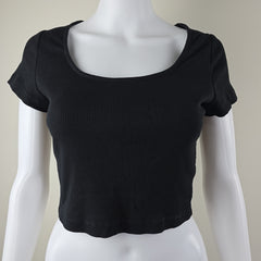 Black sleeveless top on a mannequin against a neutral background
