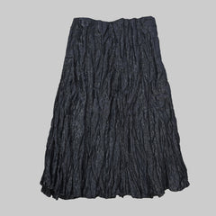 Folded black fabric on a tiled floor