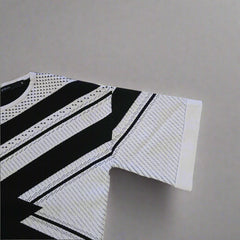 Black and white patterned Top on a tiled floor