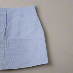Light blue skirt on a beige background