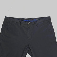 Dark black pants on a tiled floor