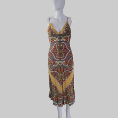 Mannequin wearing a patterned dress with a plain background