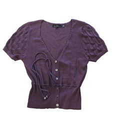 Purple textured garment on a tiled floor