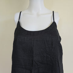 Black top on a mannequin against a beige background