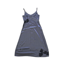 Grey dress with black floral patterns on a light background.