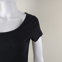 Black sleeveless top on a mannequin against a plain background