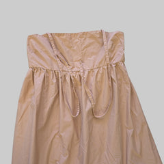 Brown strapless dress on a tiled floor