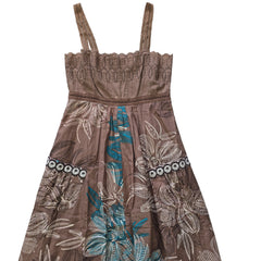 Brown dress with floral embroidery on a tiled floor