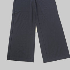 Two dark black pants on a tiled floor