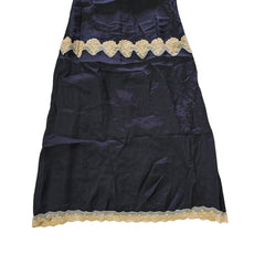 Black dress with beige lace details on a light background