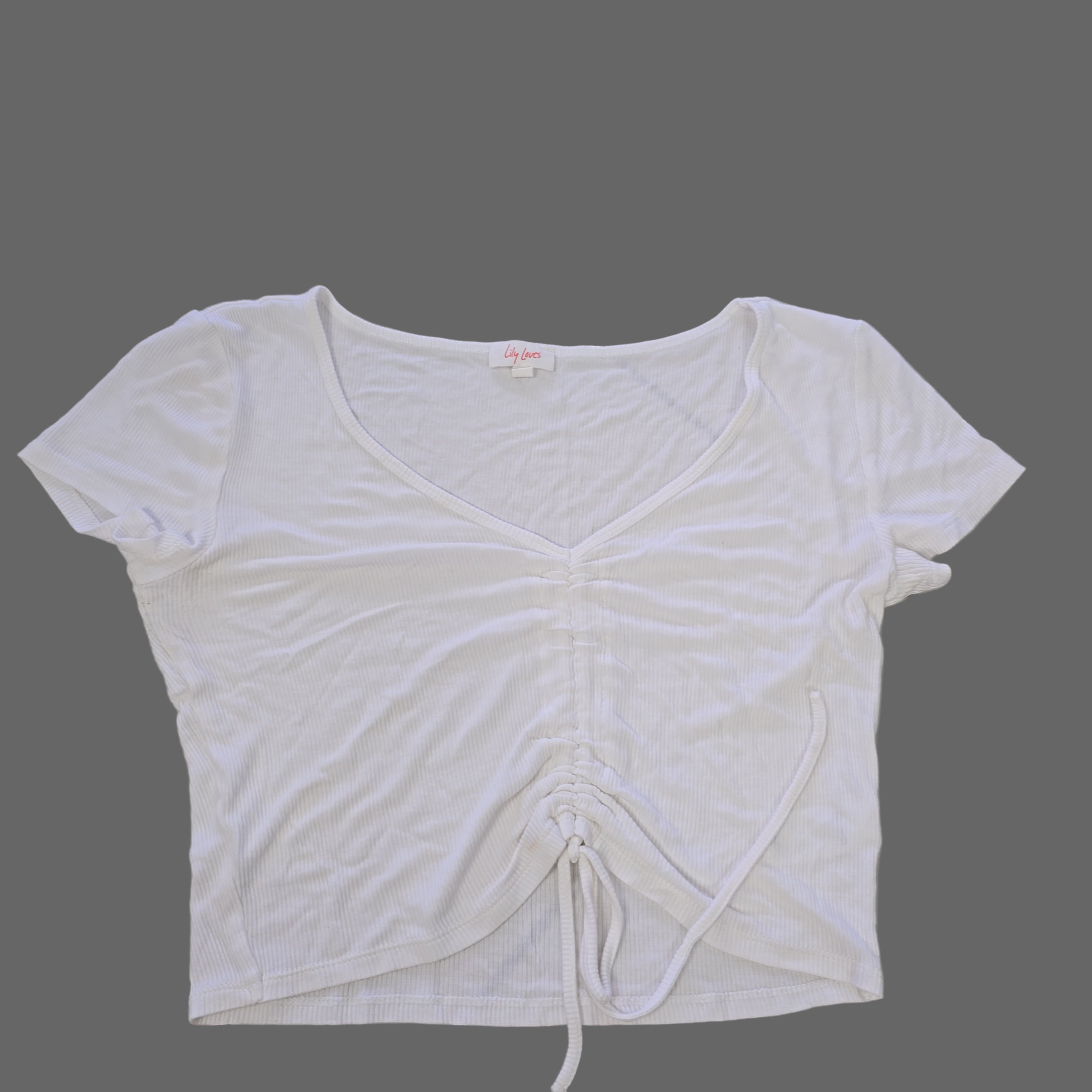 White sleeveless top on a tiled floor