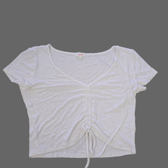 White sleeveless top on a tiled floor