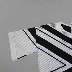 Black and white patterned sleeveless top on a tiled floor