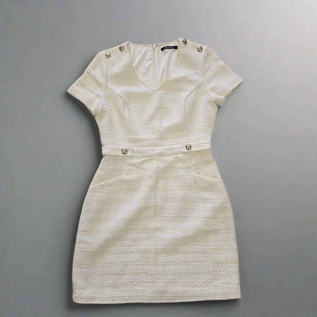 Beige textured dress on a tiled floor