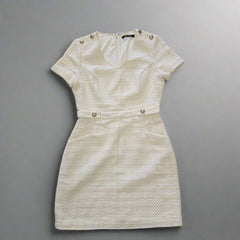 Beige textured dress on a tiled floor