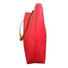 Red handbag with a visible brand logo on a light background