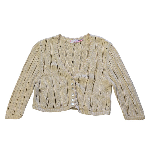 Beige knitted cardigan on a tiled floor 2736