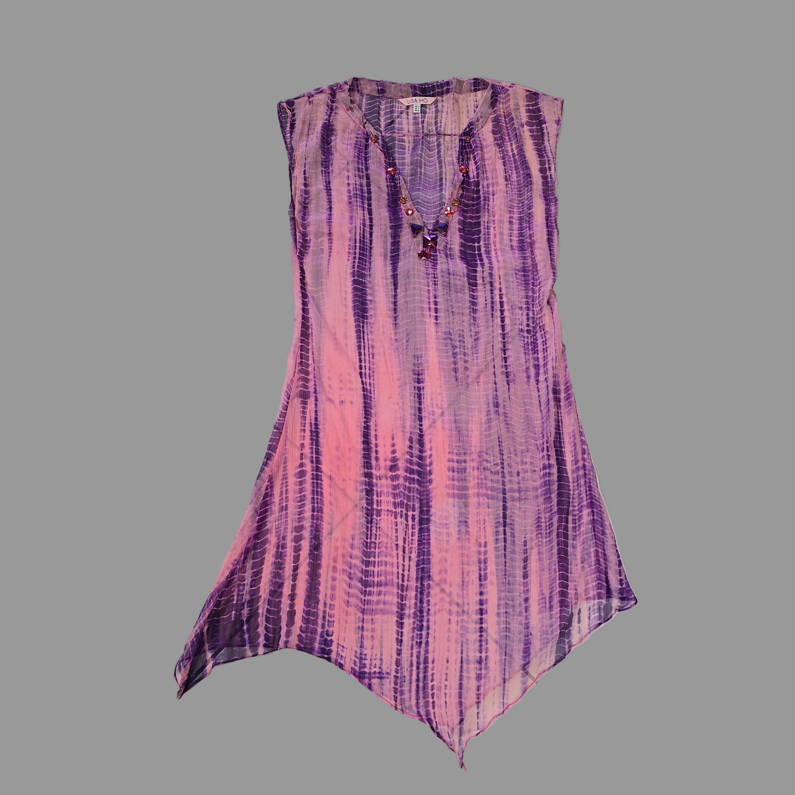 Purple and pink patterned kaftan on a tiled floor