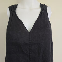 Black top on a mannequin against a beige background