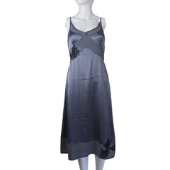 Gray dress with black floral patterns on a mannequin against a plain background