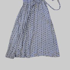 Blue and white patterned dress on a tiled floor