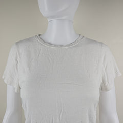 White tank top on a mannequin against a plain background