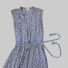 Blue and white patterned dress on a tiled floor