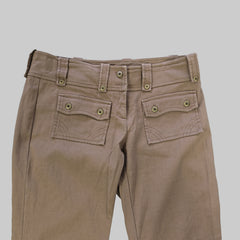 Brown pants with multiple pockets on a tiled floor