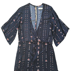 Black dress with white and pink patterns on a light background