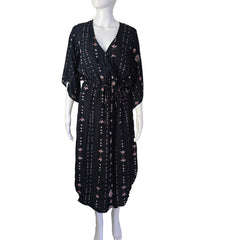 Black patterned dress on a mannequin against a neutral background