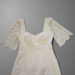 White lace dress on a tiled floor