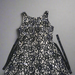 Black lace dress on a tiled floor