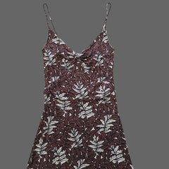 Brown dress with white floral pattern on a tiled floor