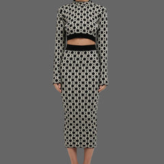 Woman wearing a black and white patterned outfit on a white background