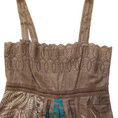 Brown lace top with intricate patterns on a tiled floor background